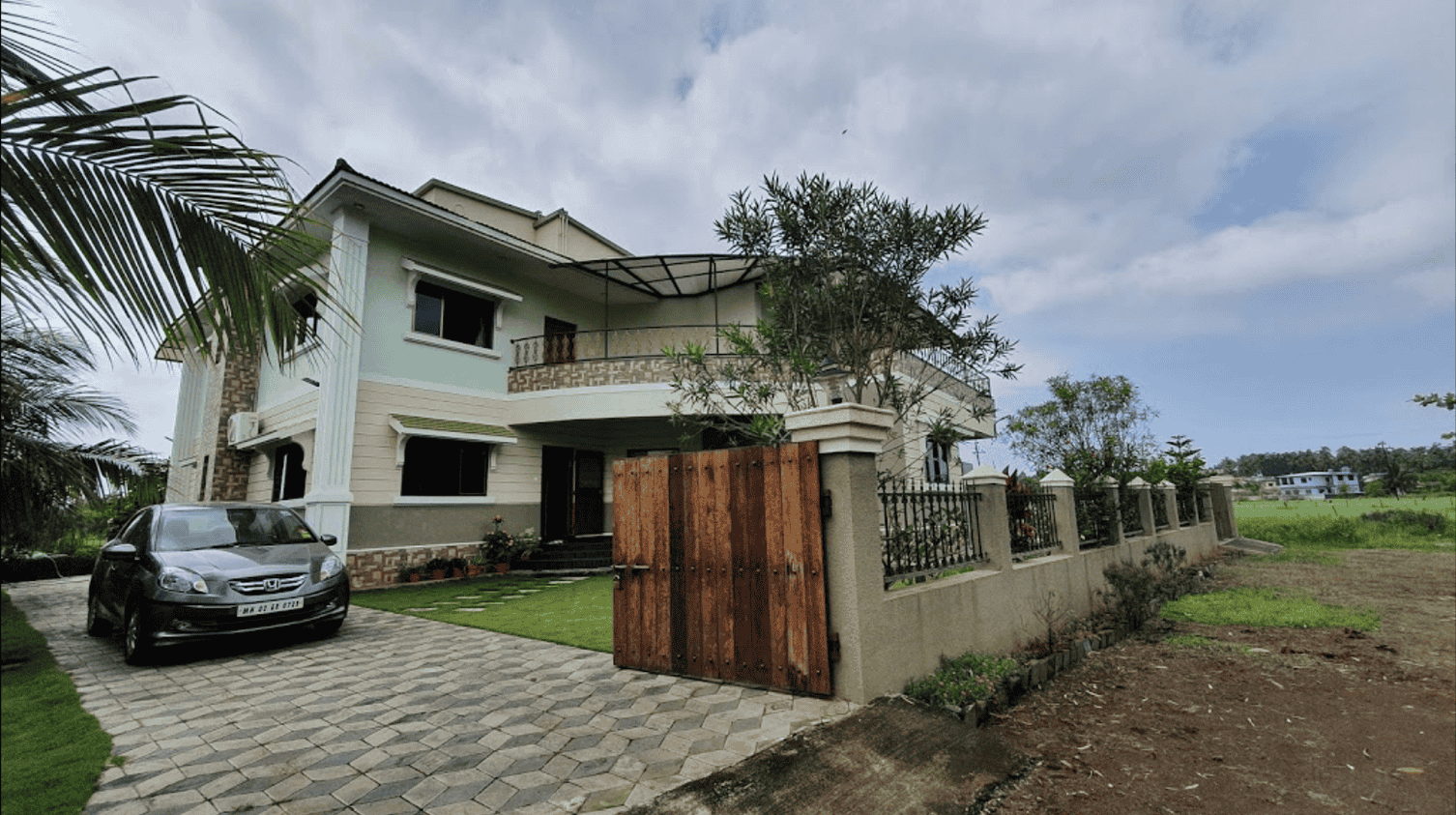 Aerial view of the villa with well maintained lawn and parking space