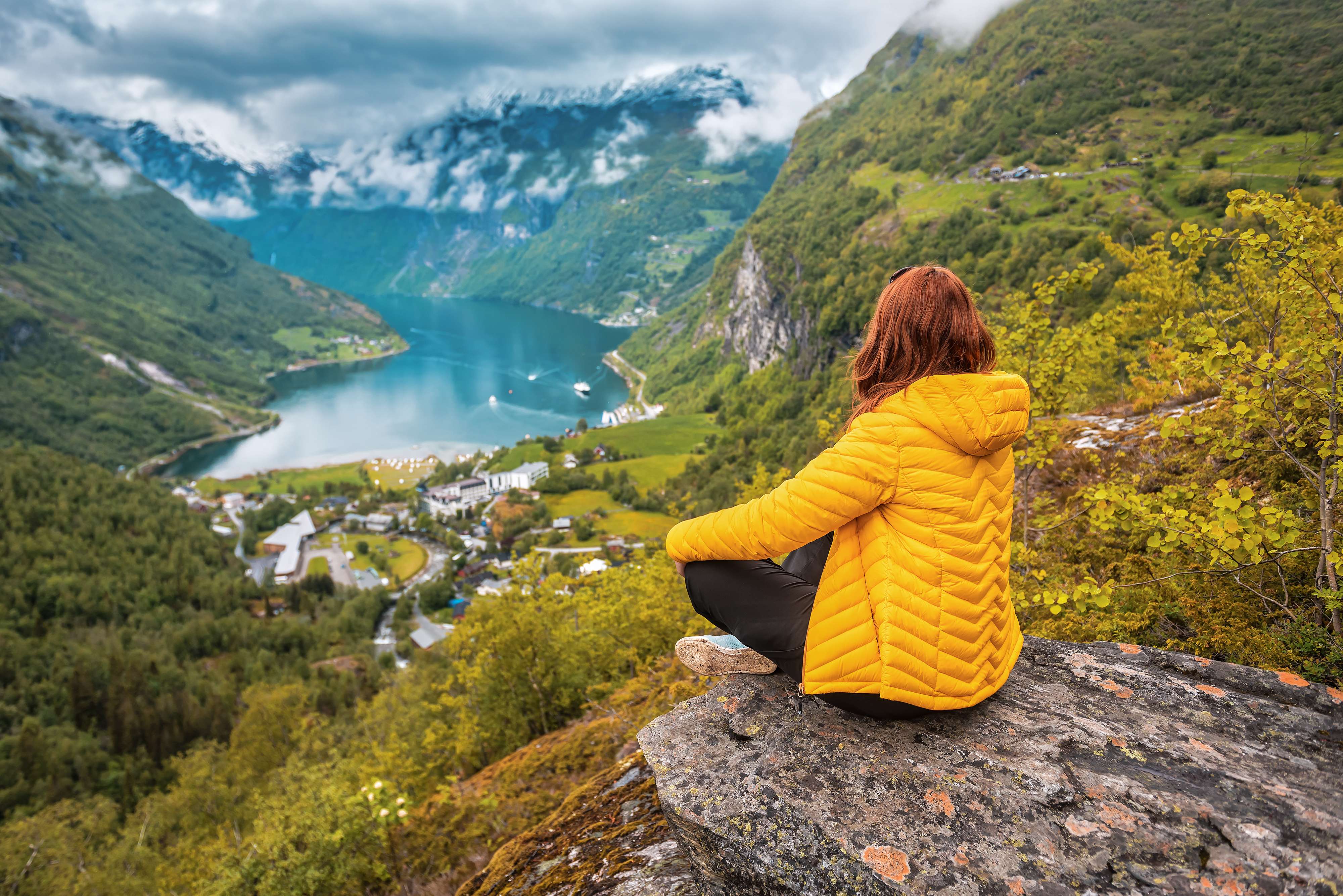 Woman admiring the views of Norwegian Geiranger fjord