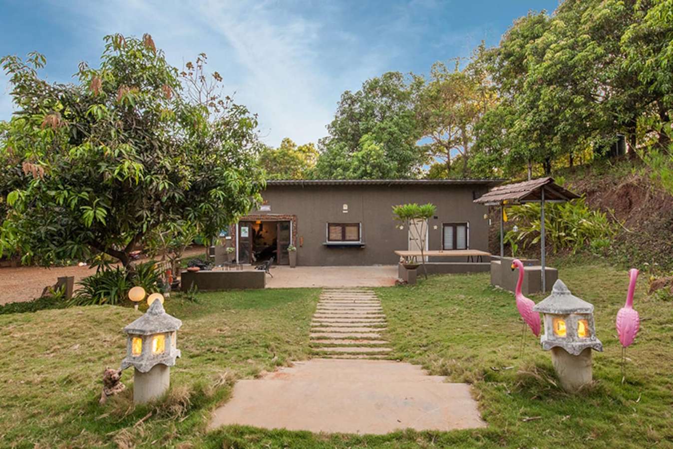 Front view of the villa with lush green lawn