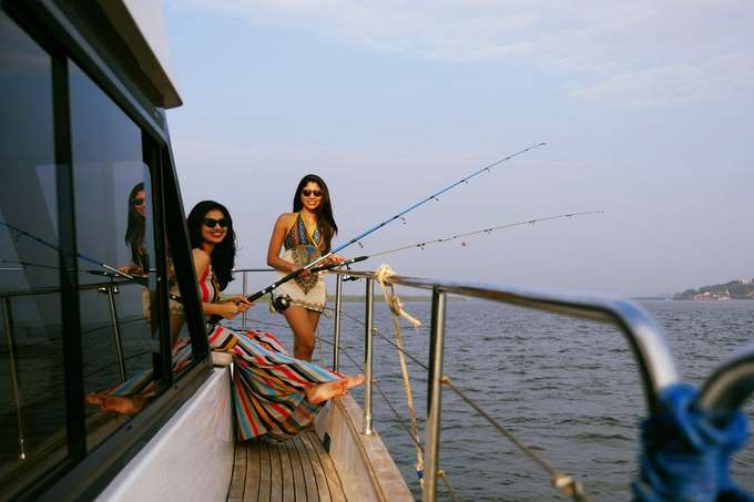 Enjoy serene fishing moments on a luxurious yacht, creating lasting memories in Goa's calm waters