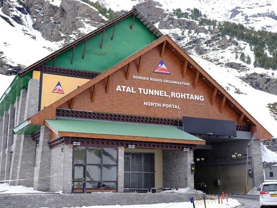 Marvel at the Atal Tunnel North Portal, an engineering masterpiece surrounded by snowy mountains