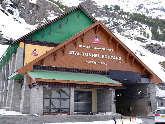 Marvel at the Atal Tunnel North Portal, an engineering masterpiece surrounded by snowy mountains