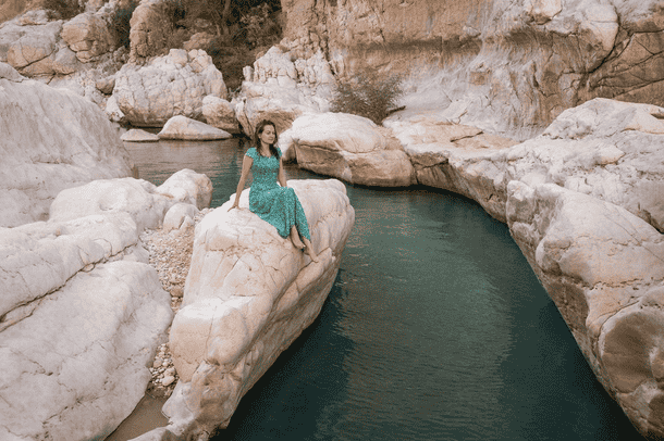 Sit beside the turquoise pools of Wadi Bani Khalid, surrounded by rugged cliffs