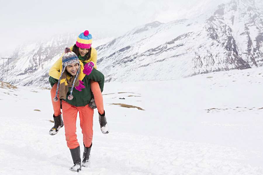 Couple having fun in snow in Manali during winters