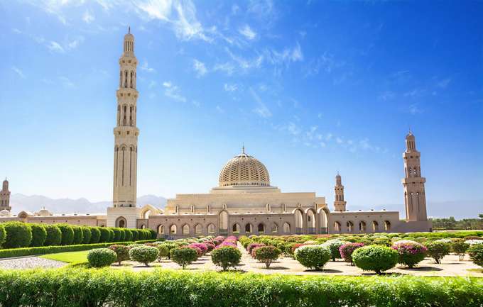 Marvel at the stunning architecture of the Muscat Grand Mosque