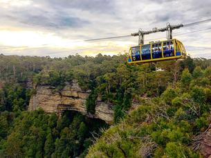 Soar above breathtaking Jamison Valley in the Scenic Skyway with glass floor views at Scenic World