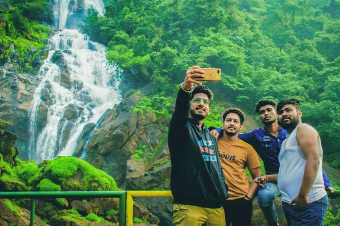 Visitors clicking pictures against the backdrop of Dudhsagar Falls 