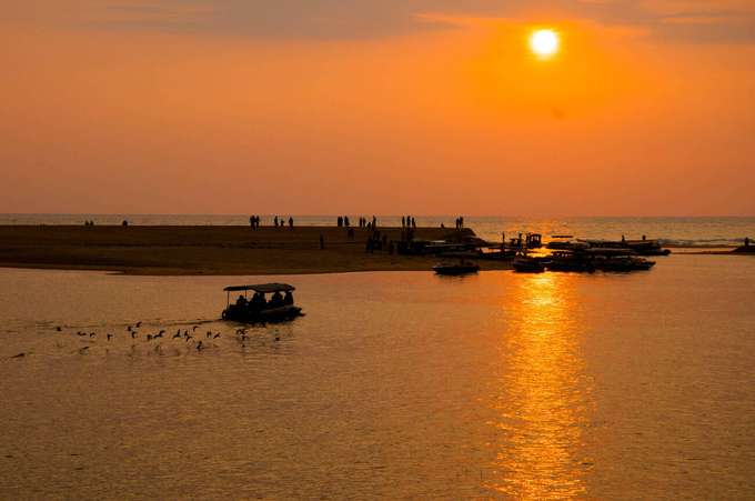 Sail along the Neyyar River at Poovar Island as the golden sunset colors the sky