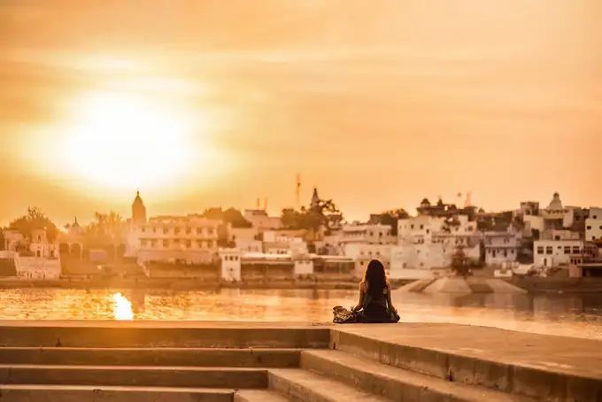 Girl admiring the stunning sunset at Pushkar Lake