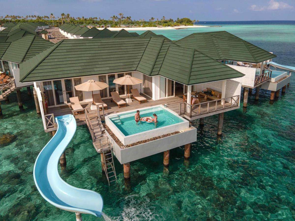 Couple enjoying their breakfast at the Water Villa with Pool and Slide