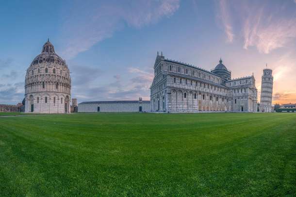 View of Pisa Baptistery, Pisa Cathedral and Leaning Tower of Pisa at Piazza dei Miracoli at sunset