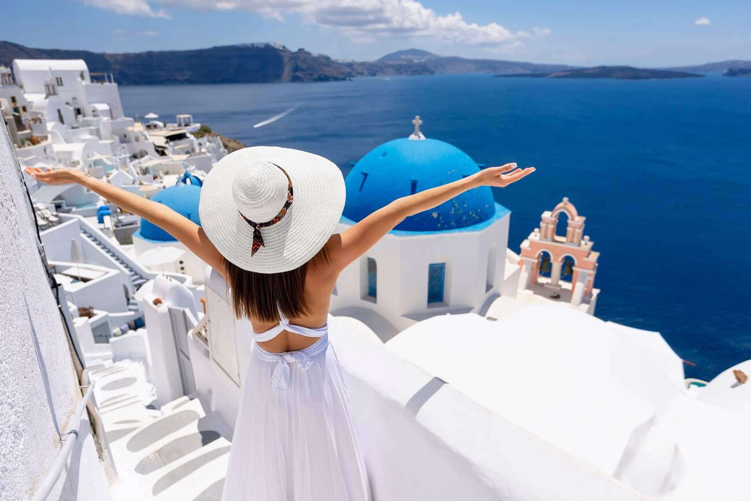 Girl enjoying the scenic coastal views from Santorini