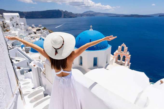 Girl enjoying the scenic coastal views from Santorini