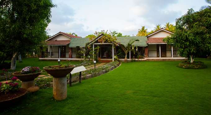 Entrance view of the homestay with lush green lawn