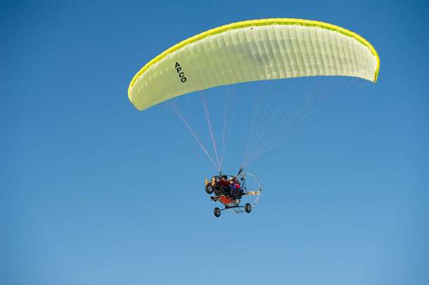 Experience the thrill of power paragliding in Sohna, with views of Gurgaon’s vast landscapes