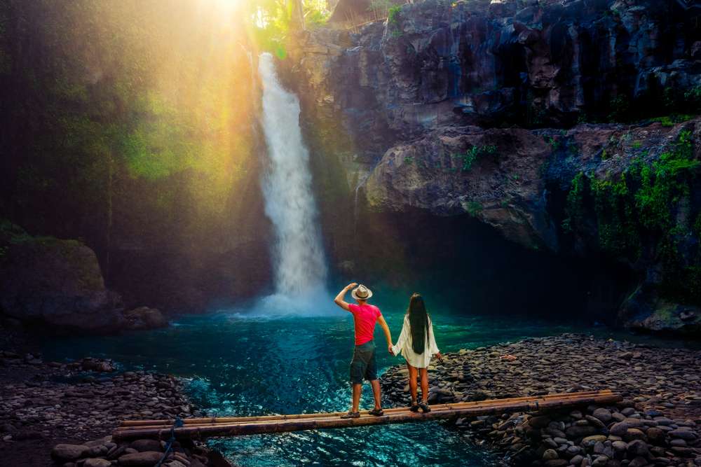 Couple admiring waterfall in Bali