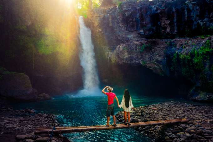 Couple admiring waterfall in Bali