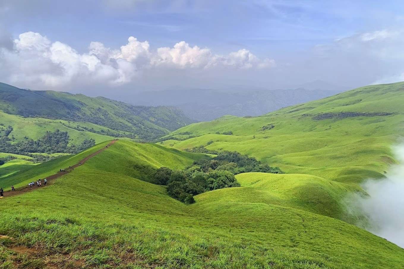 Marvel at stunning views of lush valleys and serene landscapes from Netravathi Peak
