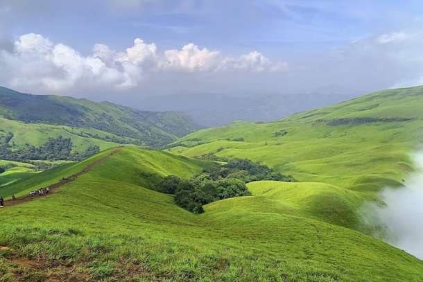 Marvel at stunning views of lush valleys and serene landscapes from Netravathi Peak