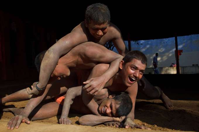 Feel the vibrant atmosphere as wrestlers showcase their skills and passion.