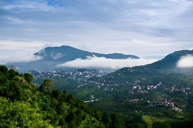 Experience the serene beauty of Manali’s lush green forests and majestic mountains