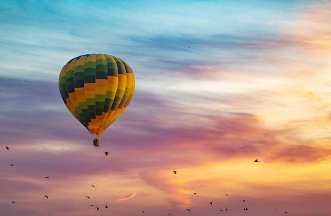 Enjoy a balloon ride during the sunrise as the sky bursts into shades of gold and crimson