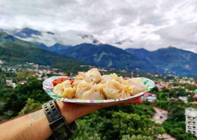 Savor the steamy delight of Tibetan momos while enjoying the breathtaking views