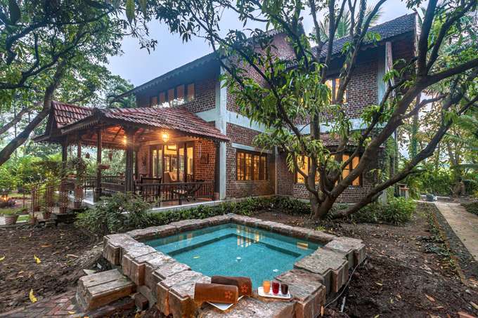 Outdoor swimming pool alongside the entrance of villa