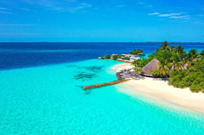 Stay in a beachfront bungalow, steps away from the turquoise lagoon