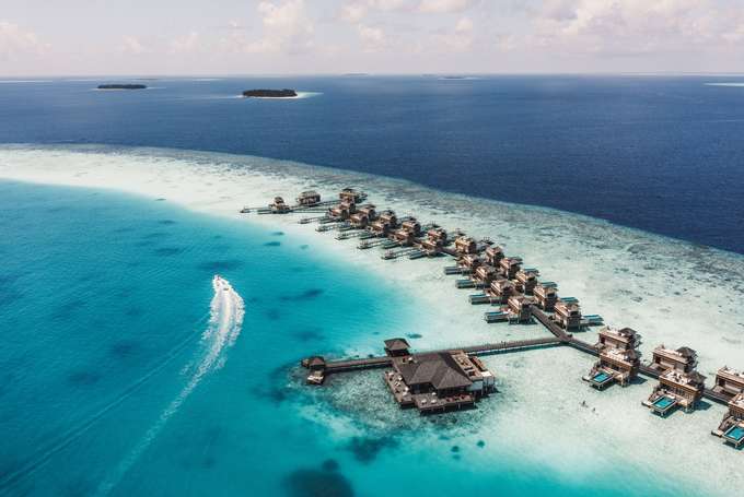 Admire the breathtaking views of water villas perched over crystal-clear waters