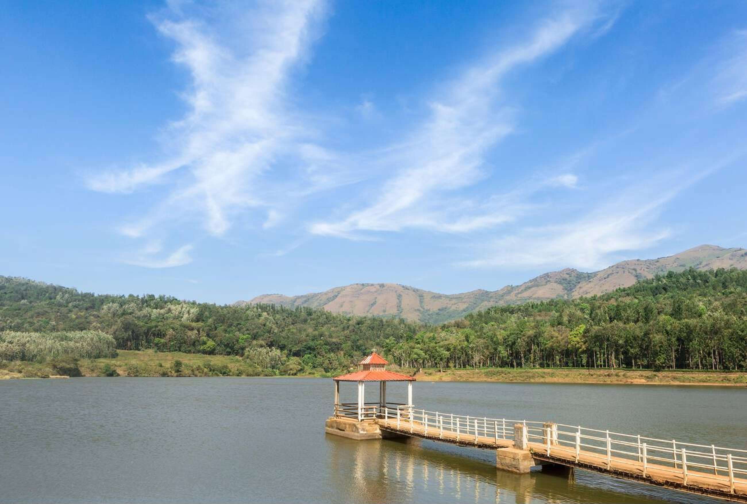 Relax by Hirekolale Lake’s calm waters amidst mountain views
