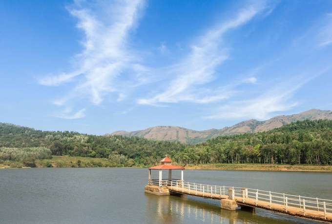 Relax by Hirekolale Lake’s calm waters amidst mountain views