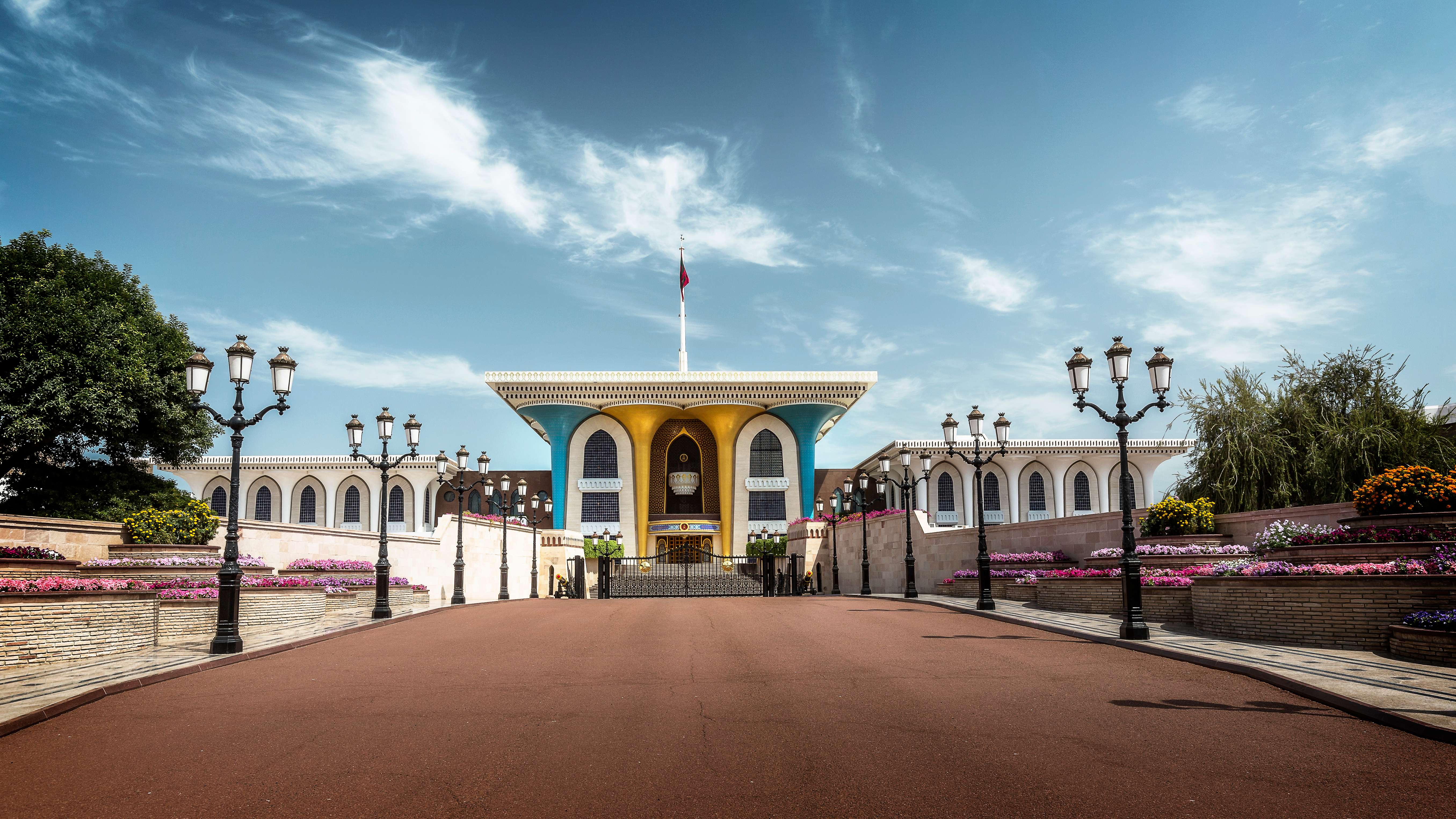 Marvel at the striking blue and golden facade of Al Alam Palace