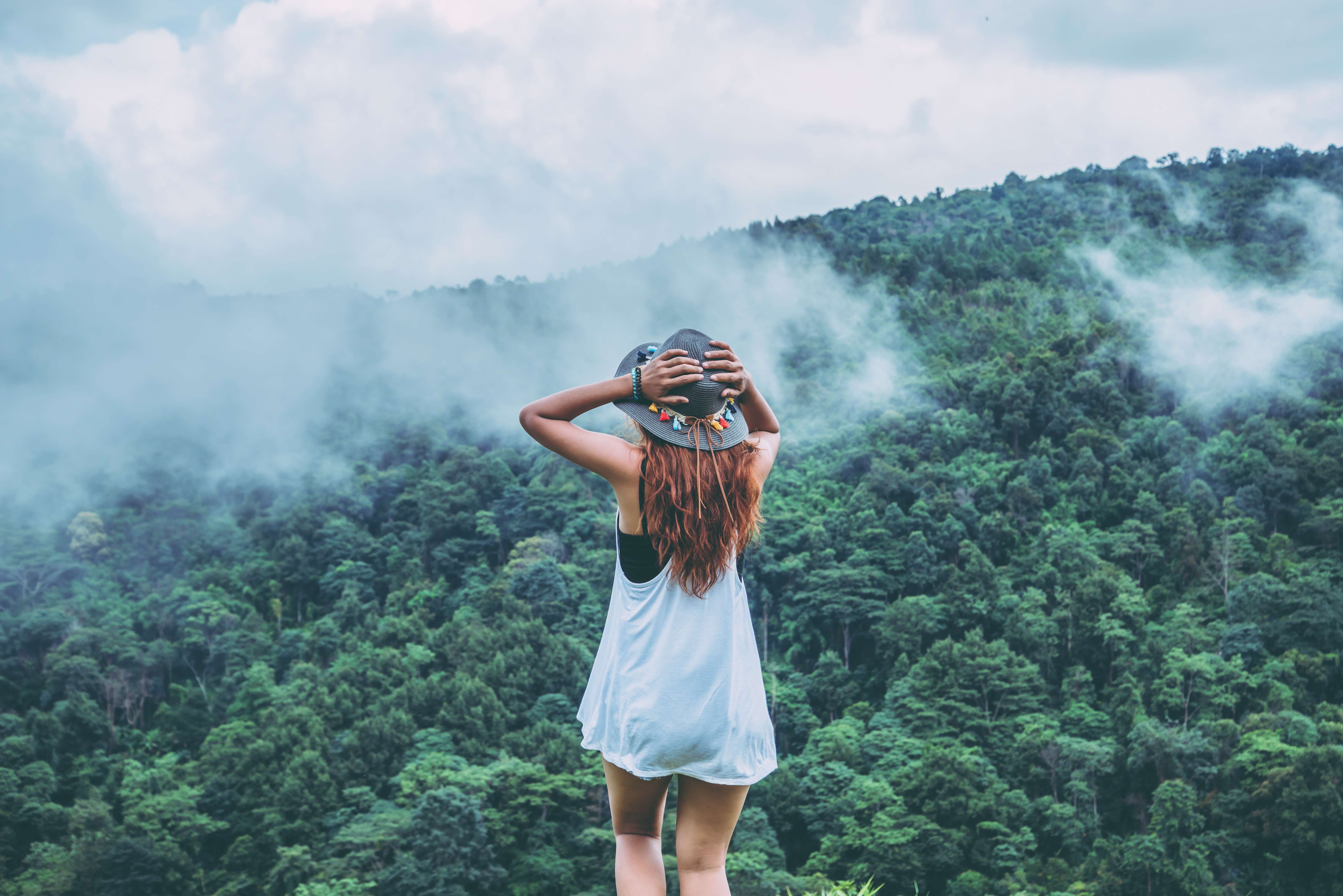 Woman admiring the views of misty mountains