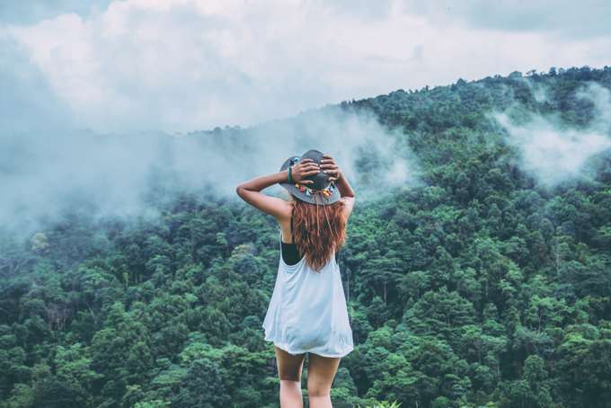 Woman admiring the views of misty mountains
