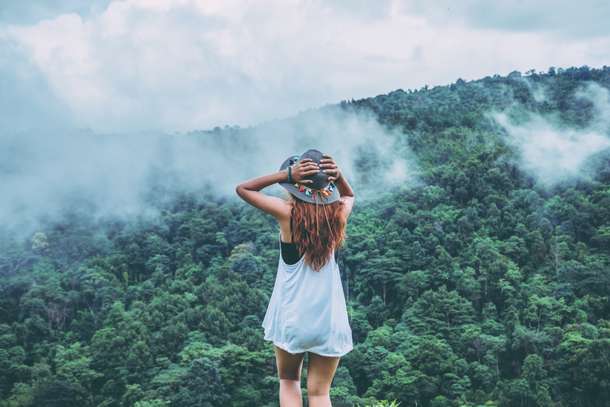 Woman admiring the views of misty mountains