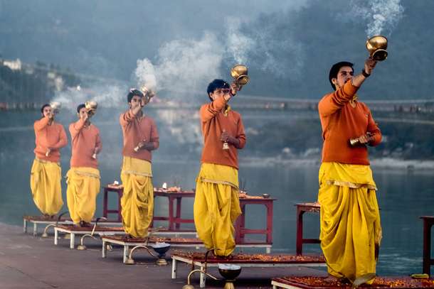 Feel the energy of evening Ganga Aarti in Rishikesh, as the air fills with chants and light