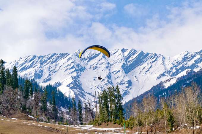 Feel the wind rush through your hair as you paraglide over Solang Valley