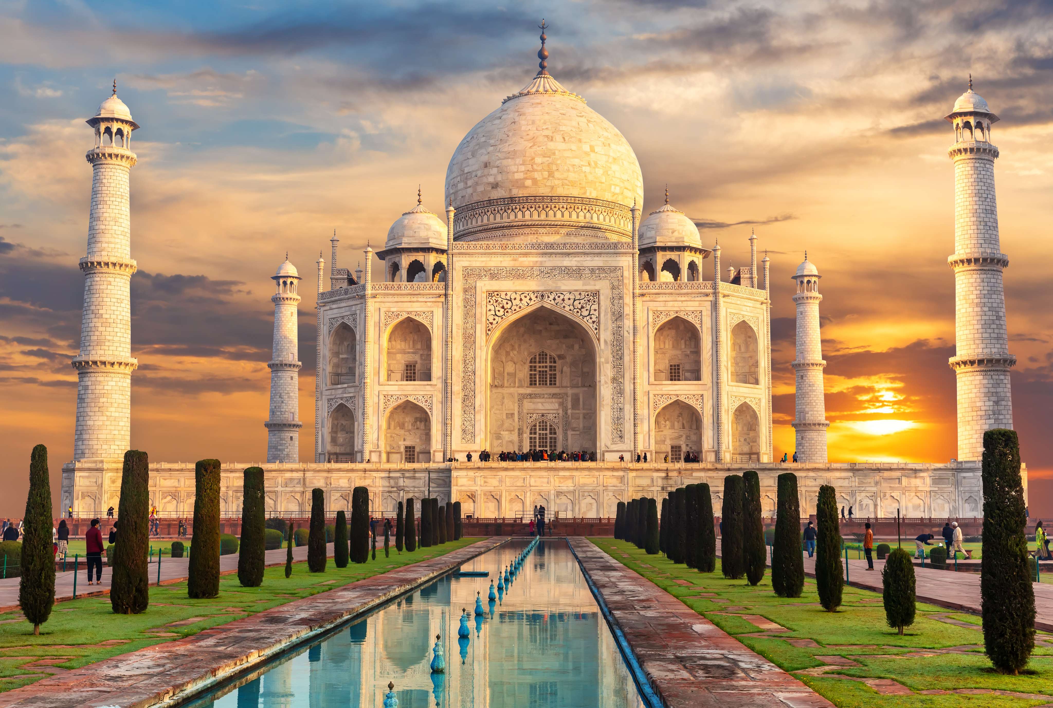 Witness the Taj Mahal glow softly under the golden hues of sunrise