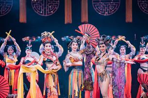 Watch performers light up the stage in sparkling outfits