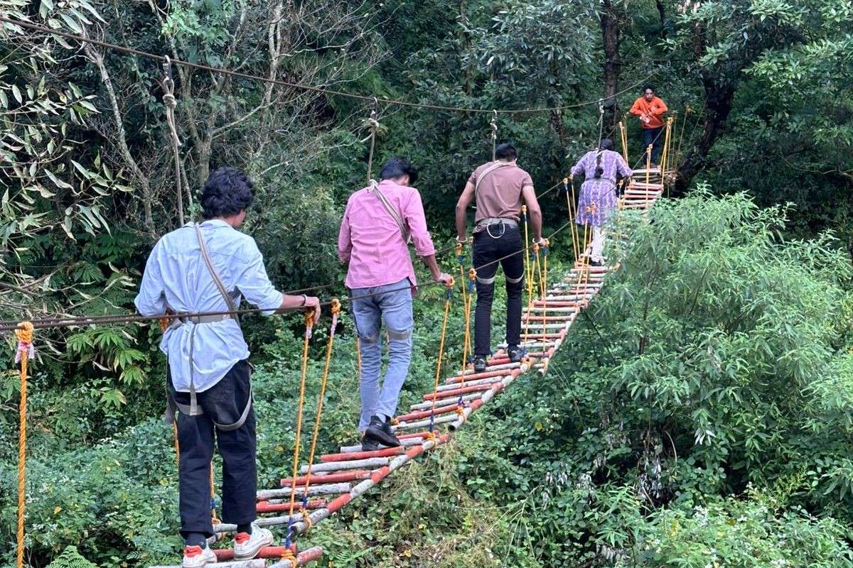 Experience the thrill of walking across a suspension bridge high above the ground