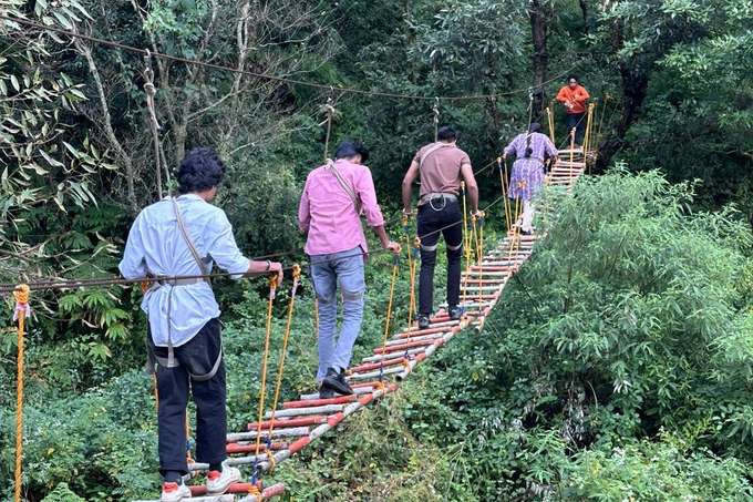 Experience the thrill of walking across a suspension bridge high above the ground
