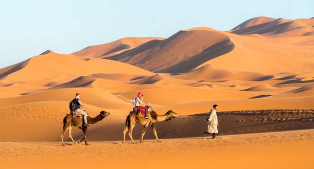 Enjoy a camel ride with your partner cross the iconic Sahara desert