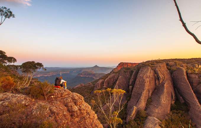 Marvel at the scenic surroundings as you ascend to rocky mountains in Uluru