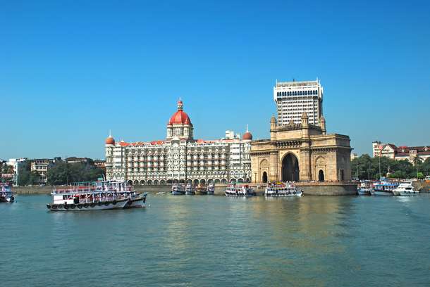 Take a look at the iconic Gateway of India & Taj Hotel while bording the ferry