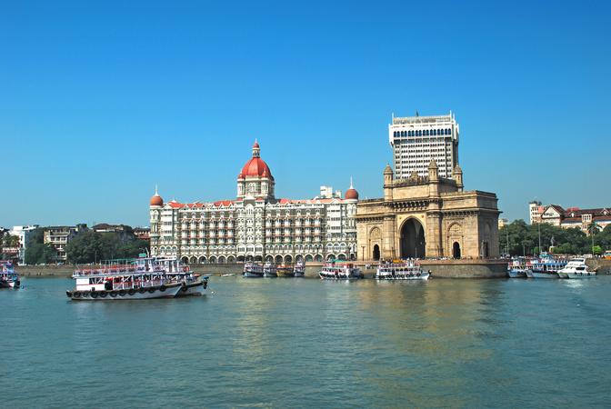 Take a look at the iconic Gateway of India & Taj Hotel while bording the ferry