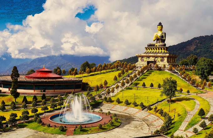 Marvel at the stunning Buddha statue of Ravangla, a 130-ft masterpiece framed by the Himalayas