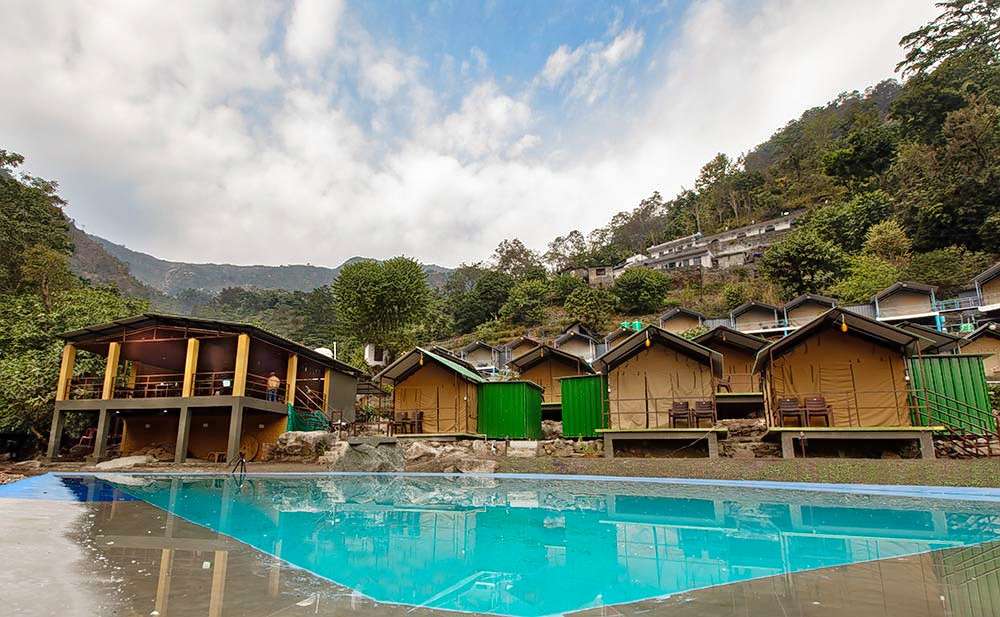 Relax and unwind by a swimming pool while camping in Rishikesh