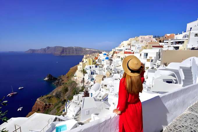 Girl admiring the stunning sea views from Santorini