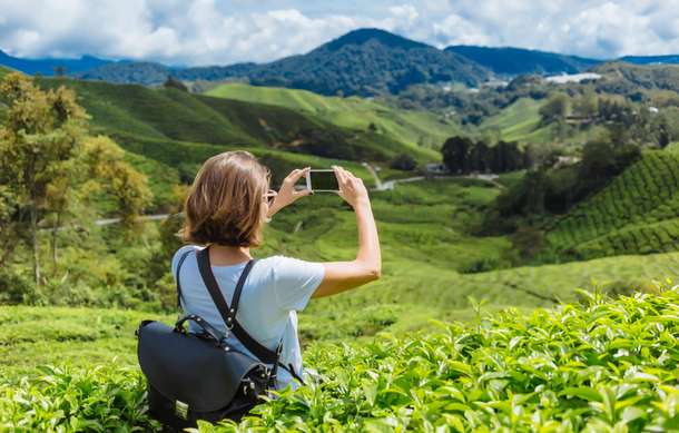 Tourist admiring lush greenery of Munnar